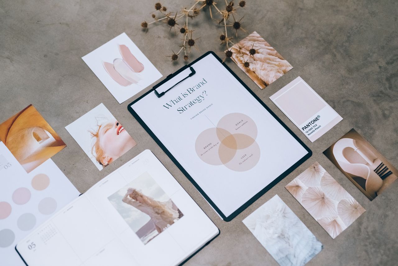 our-story Flat lay of a minimalist brand strategy moodboard on a concrete surface.