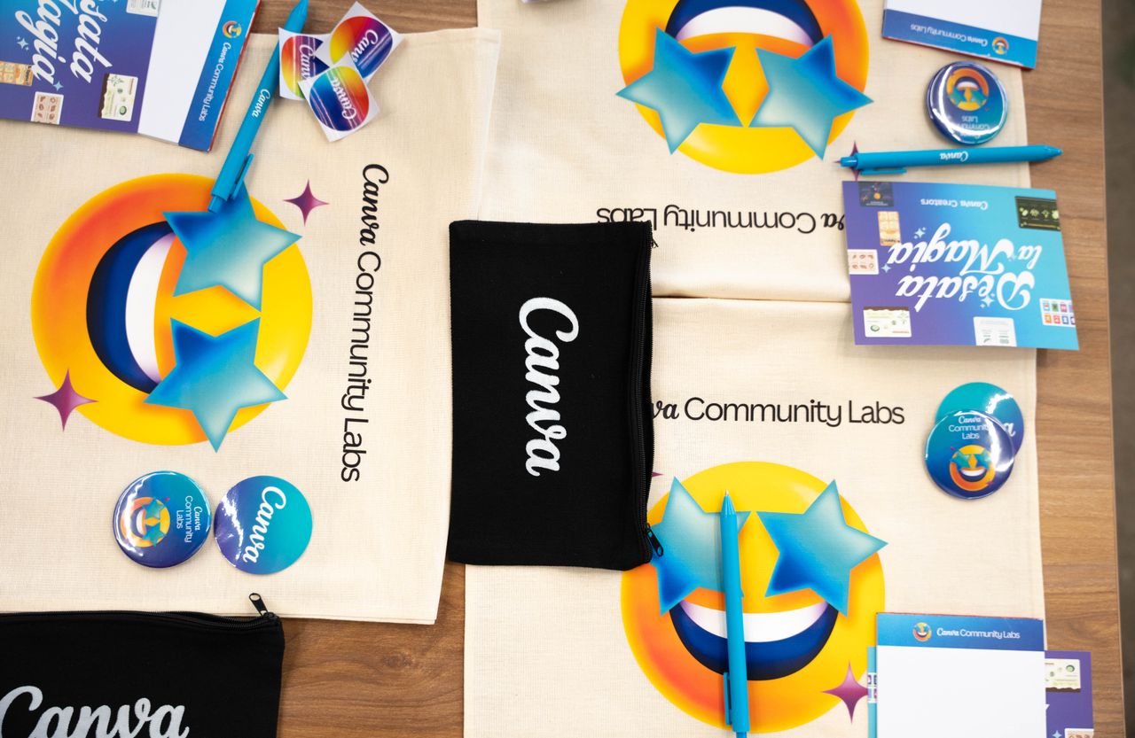 services-02 Flat lay of Canva Community Labs merchandise with vibrant design and branding elements.